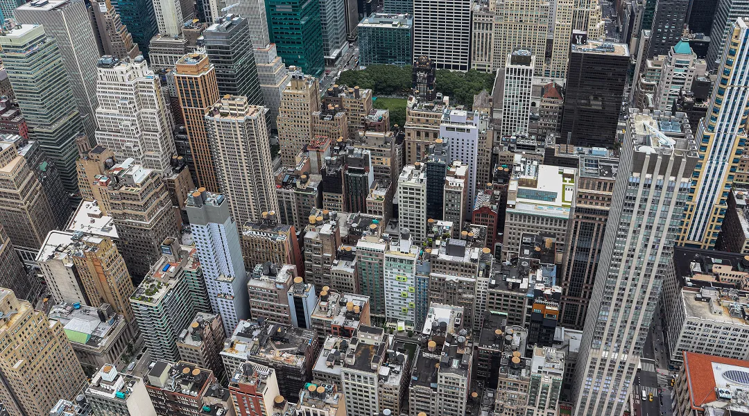 Aerial view of densely packed high-rise buildings and skyscrapers in a metropolitan city.